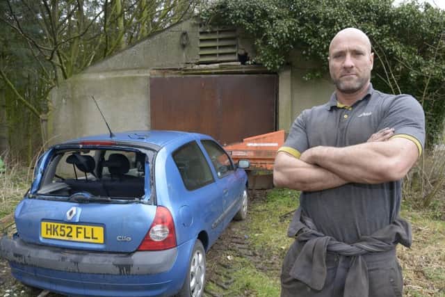 David Parker outside the storage area were the car was stolen. NBFP PA1611-4