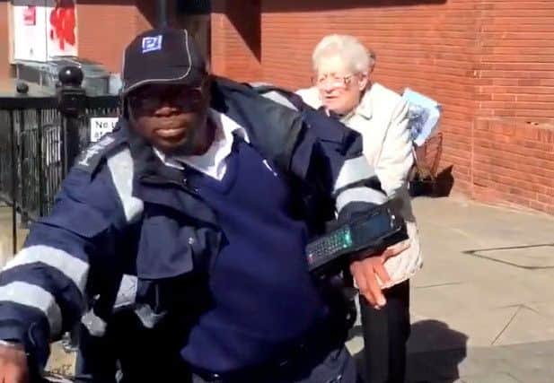 Video grab from video. See SWNS story SWTAXI; Angry Cabbie issued with a parking fine moments after helping a disabled pensioner out of his car. A taxi driver was slapped with a fine for parking on double yellow lines to help a disabled pensioner out of his car. The cabbie momentarily stopped so that his elderly passenger who uses a walker to help her stand, could disembark.But the eager warden issued the ticket within a minute of the vehicle stopping. A video of the angry exchange between the driver, warden and the customer has gone viral, being viewed more than 135,000 times online.Dan Robinson who owns The Chauffeur Company based in Chelmsford, Essex, shared footage of the council traffic warden putting the fine on his employee's windscreen outside a Marks and Spencer store in the city on Tuesday.