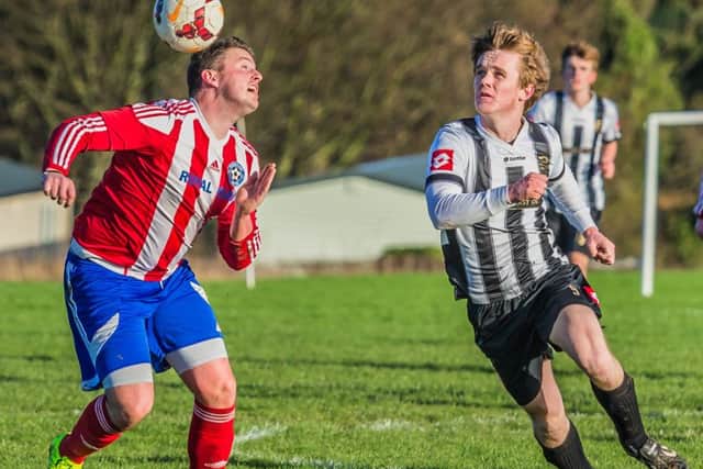 Hunmanby United, red and white kit, are through to the final of the East Riding Senior County Cup