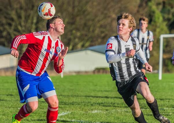 Hunmanby United, red and white kit, are through to the final of the East Riding Senior County Cup