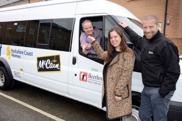 YCH Chief Exec Shaun Tymon, left, picks up the keys to the new community minibus with Jennifer Jaconelli, acting corporate communications manager at McCain Foods, and Beerhouse Self Drive Hire Director, Phil Moses.