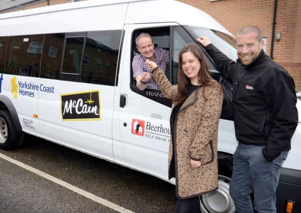 YCH Chief Exec Shaun Tymon, left, picks up the keys to the new community minibus with Jennifer Jaconelli, acting corporate communications manager at McCain Foods, and Beerhouse Self Drive Hire Director, Phil Moses.
