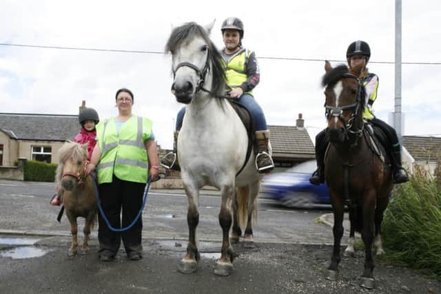 Joann Pollock complaining that drivers have no idea how to act when passing horses on the road. Lucy Corroon (7) on Halle; Lauren Hamilton on Merlin; Sophie Corroon (10) on Coco.