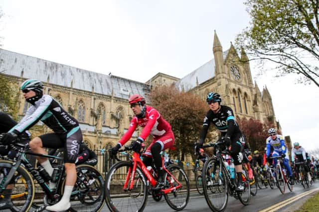 Tour de Yorkshire cyclists pass Beverley Minster.