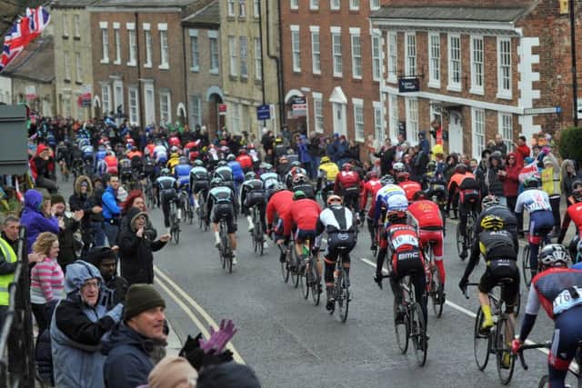 The peloton makes its way down Knaresborough High Street in the rain on Stage One of the Tour de Yorkshire.