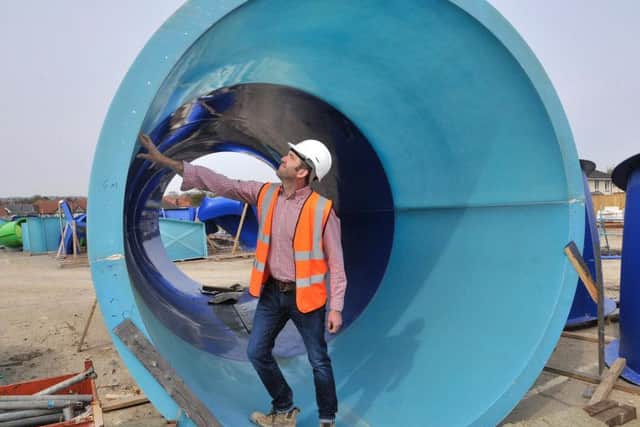 David Bloxham of Benchmark stands in a piece of one of the Water Park's slides