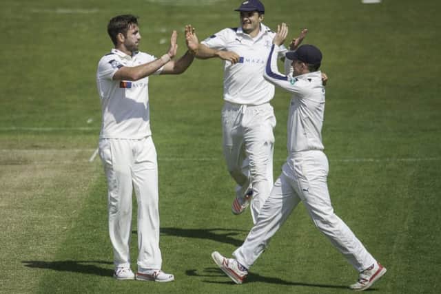 Yorkshire's Liam Plunkett is congratulated by Jack Brooks & Gary Ballance on dismissing Surrey's Rory Burns. Picture: Allan McKenzie/SWpix.com