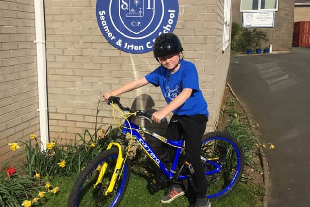 Harry Baker, eight, will cycle 21 miles from Seamer to Whitby for St Catherines Hospice