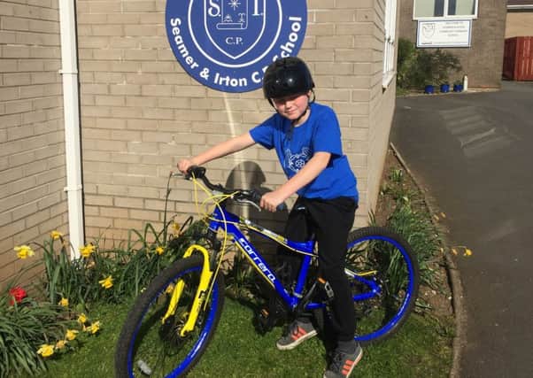 Harry Baker, eight, will cycle 21 miles from Seamer to Whitby for St Catherines Hospice
