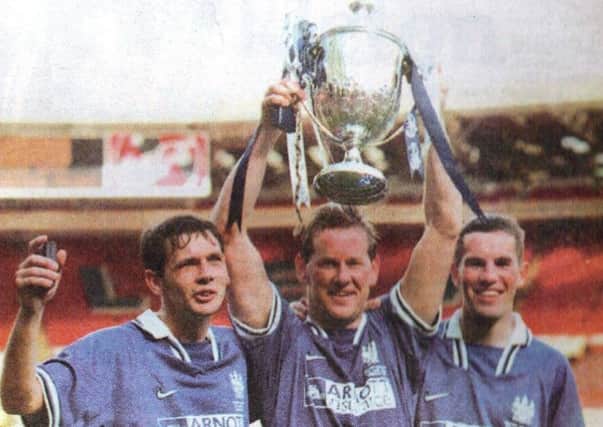 Whitby Towns Wembley goalscorers, Andy Toman, David Logan and Graeme Williams hold the FA Vase aloft