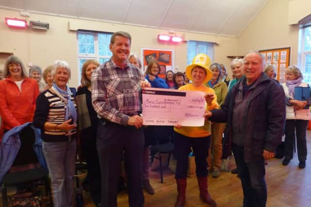 The choirs cheque presentation to Scarborough Daffodils