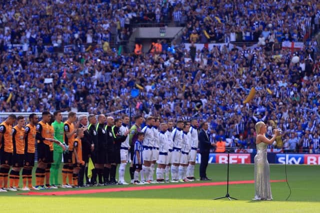 Soprano singer Emily Haig sings the national anthem as the teams line up before the Championship Play-Off Final.