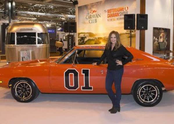 Actress Catherine Bach, the original Daisy Duke in The Dukes of Hazzard, is pictured with General Lee.