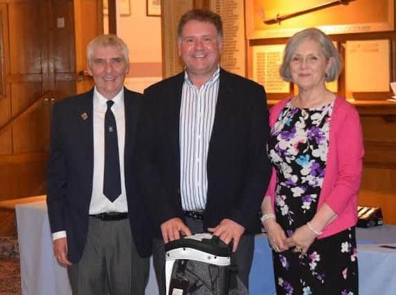 Captain Barry Poynter and his wife Patricia present Chris Wharton with the Captain's Prize