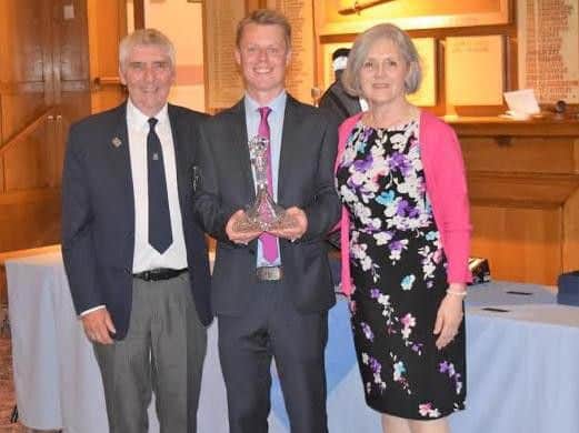 Captain Barry Poynter and his wife Patricia present Simon Boddy with his honour for the best gross score