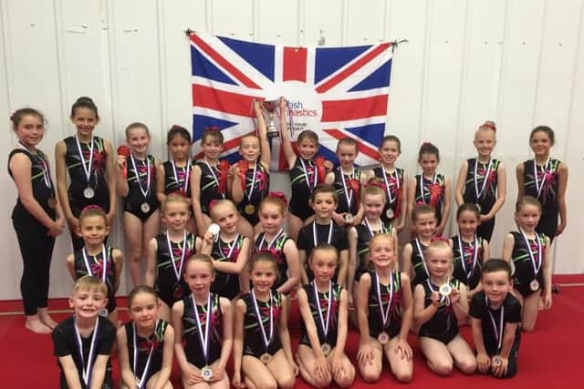 The home clubs level six gymnasts line up and show off their trophy and medals at the Scarborough Gymnastics Academy teamgym apparatus championship