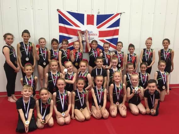 The home clubs level six gymnasts line up and show off their trophy and medals at the Scarborough Gymnastics Academy teamgym apparatus championship