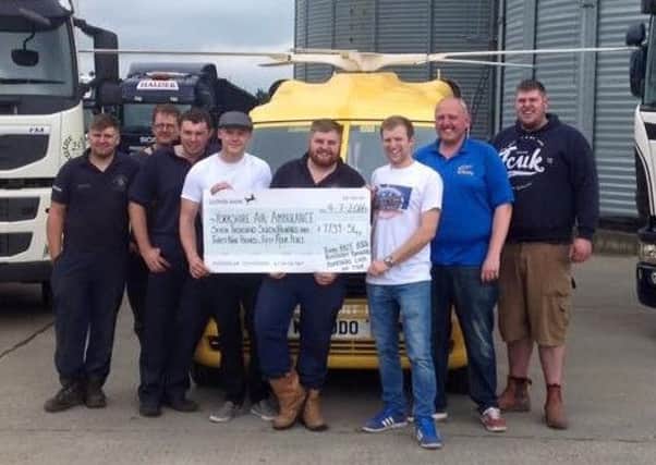 The Benidorm Bangers teams present a cheque for Â£7,739 to the Yorkshire Air Ambulance
