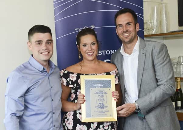 The Crown Taverns Natalie Hodgson and Steven Murray collect their Marstons Pub of the Year awards.