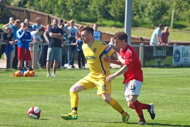 Liam Ormsby of Boro comes under pressure from Tommy Barker
