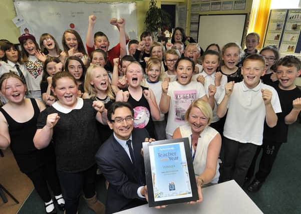 Scarborough News Editor Ed Asquith presentsTeacher of the year winner Dee McCulloch with her award as her class cheer with joy. . pic Richard Ponter 163101d