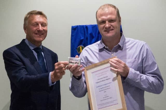 The Lord Lt presents a certificate to PC Jon Rushton.