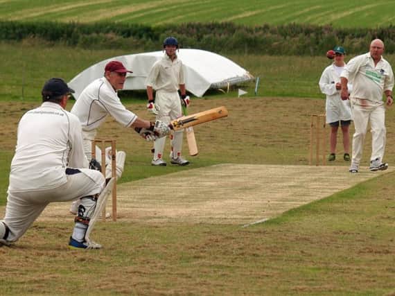 Muston 2nds' bowler Brian Anderson sends down a delivery during his side's win against Thornton Dale 2nds in Division Five. Picture: Steve Lilly.