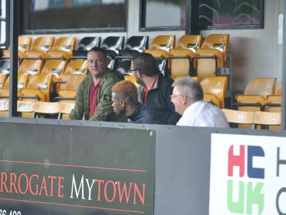 Alhassane Keita in the stand with chairman Dave Holland at Harrogate Town