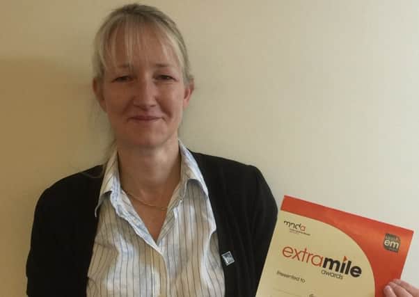Georgina Glew with her Extra Mile Award certificate.