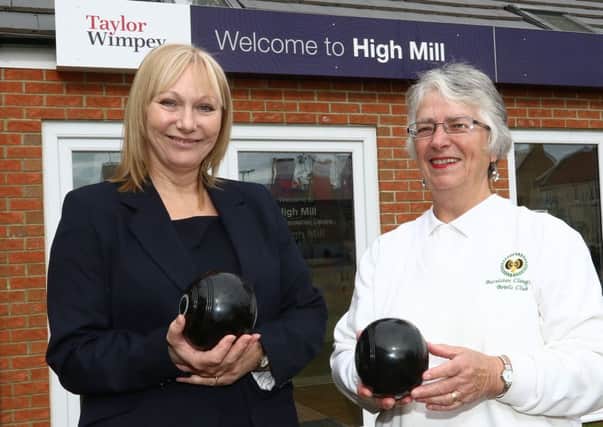 Taylor Wimpey sales executive Jacky Prouse with Burniston and Cloughton Bowls Club chairwoman Elaine Bramley.