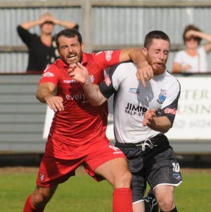 Adam Bolder holds off his man