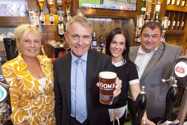 Robert Goodwill MP pours a pint during his visit to The Dickens Bar and Inn (formerly known as The Pickwick Inn).