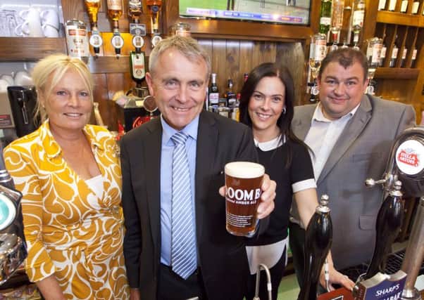 Robert Goodwill MP pours a pint during his visit to The Dickens Bar and Inn (formerly known as The Pickwick Inn).