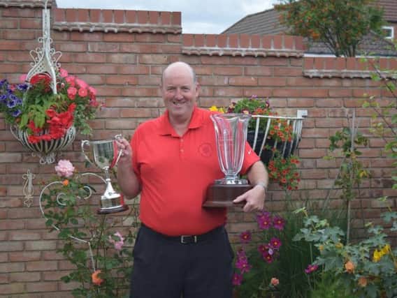 North Cliff skipper Alan Richardson at his home with his England Golf Cup and keepsake vase