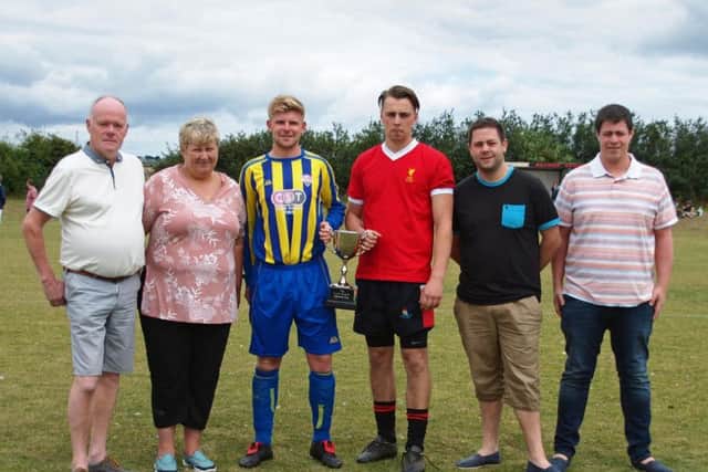 The Baron family join captains Luke Tinker and Adam North ahead of the cup match. 152232b