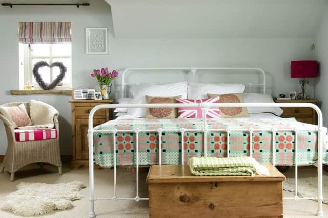 A Queen size bed from M&amp;S, covered with a pretty Welsh throw that belonged to anaunt, are off-set by the Laura Ashley Eau de Nil wall colour.