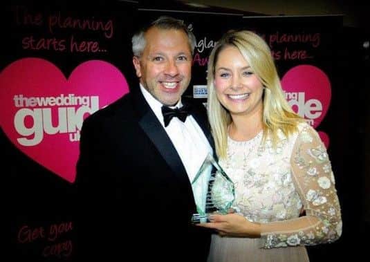 Diana McMann, owner of The Little Pearl, is pictured with her husband Brett McMann and the award.