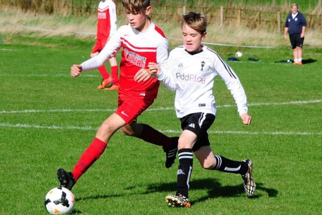 Scalby Under-14s (red kit) on the ball in their 12-1 win against Newlands