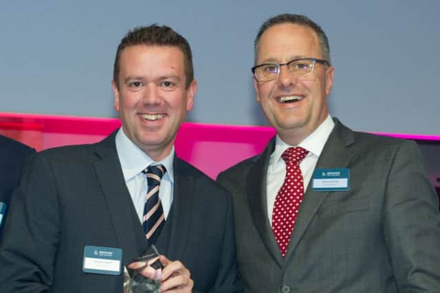 McClarrons Steven Swift accepts the award with chief network officer Richard Pitt.