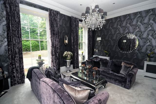 Interior designer Ben Huckerby used his client's favourite colure, purple, in the formal sitting room. The wallpaper is Albemarle Byron by Cole and Son.