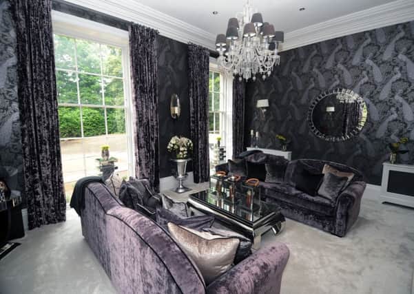Interior designer 
Ben Huckerby used his client's favourite colure, purple, in the formal sitting room. The wallpaper is Albemarle Byron by Cole and Son.