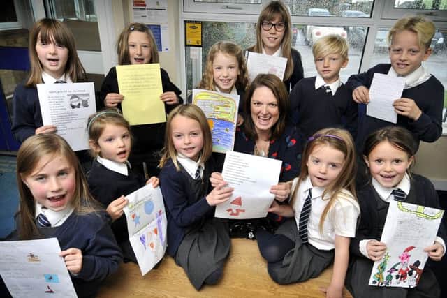 Children from St Martins School prepare their Santa Dash inspired poems with Fran Kitson from Saint Catherines.