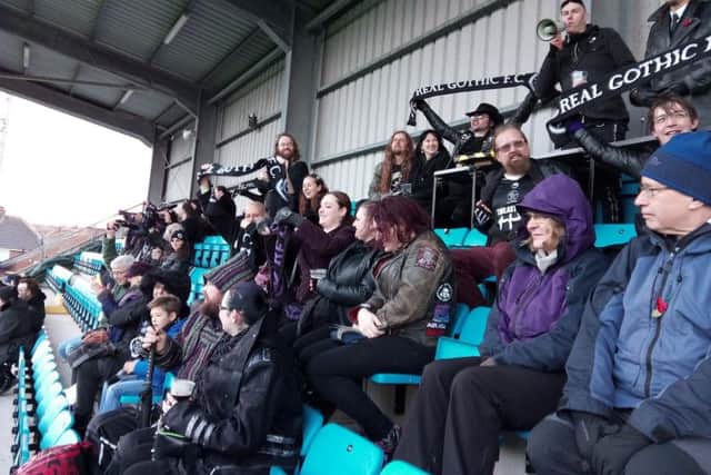 Real Gothic FC fans rise to support their team.