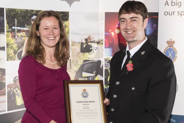 PC James Dunn is presented his silver award by Jenny Herrera