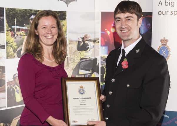 PC James Dunn is presented his silver award by Jenny Herrera