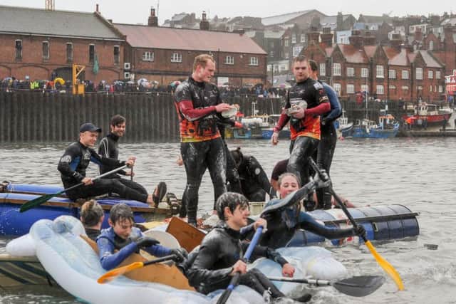 RAFT RACE --- Raft race around Scarborough Harbour which happens ever year on Boxing Day. The racers try to stop rival rafts with egg and flour bombs. Saturday 26th December 2015. HARRY ATKINSON