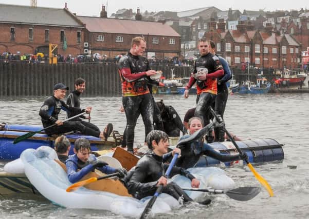 RAFT RACE --- Raft race around Scarborough Harbour which happens ever year on Boxing Day. The racers try to stop rival rafts with egg and flour bombs. Saturday 26th December 2015. HARRY ATKINSON