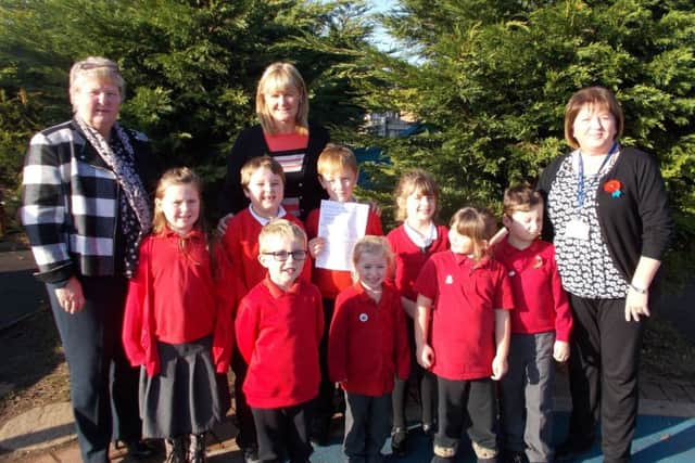 Staff and pupils at Filey Infant School celebrate the outstanding grade by inspectors.