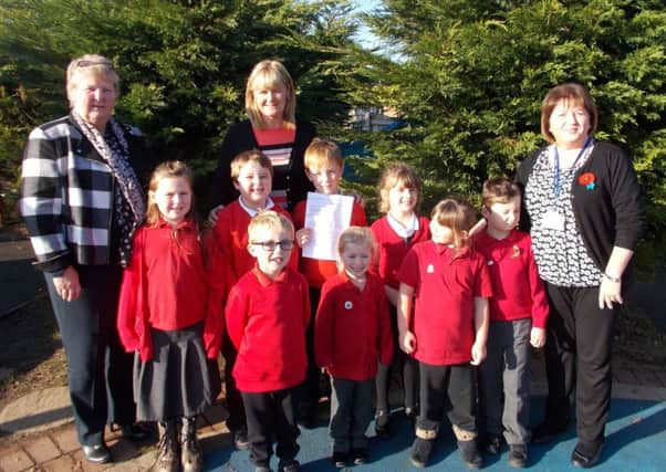 Staff and pupils at Filey Infant School celebrate the outstanding grade by inspectors.