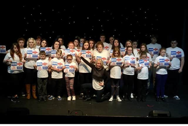 The cast of YMCAs production Christmas Cracker prepare for their shows in early December.